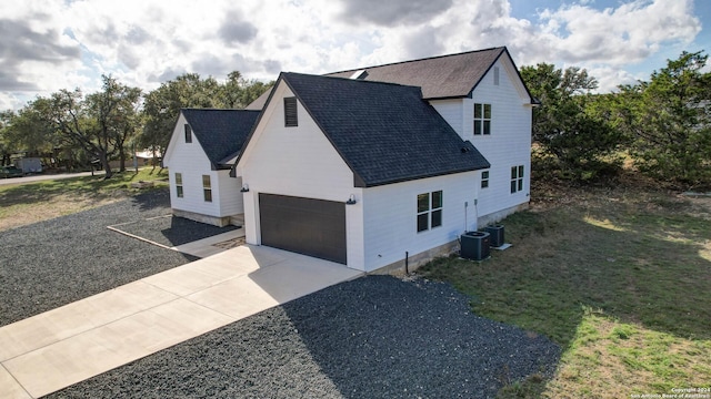 view of side of home featuring central air condition unit and a lawn