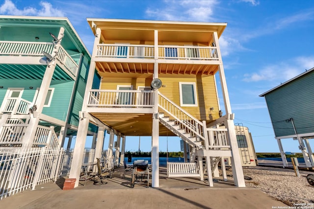 back of house with a balcony and a patio