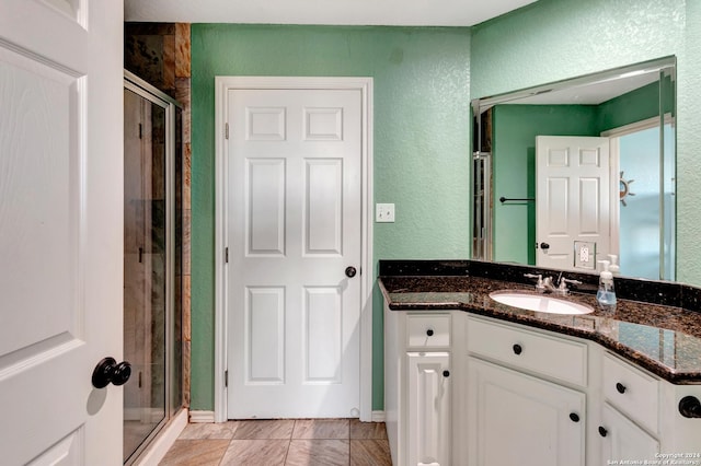 bathroom featuring vanity and an enclosed shower