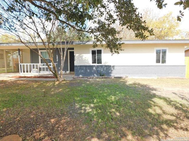 back of house featuring a carport and a lawn