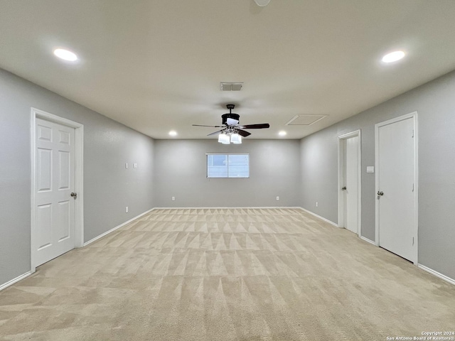 spare room with light carpet and ceiling fan