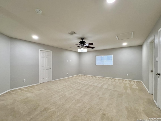 unfurnished room featuring light carpet and ceiling fan