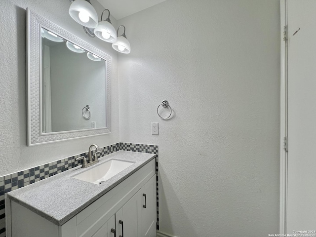 bathroom with vanity and decorative backsplash