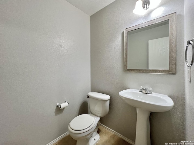 bathroom featuring tile patterned floors and toilet