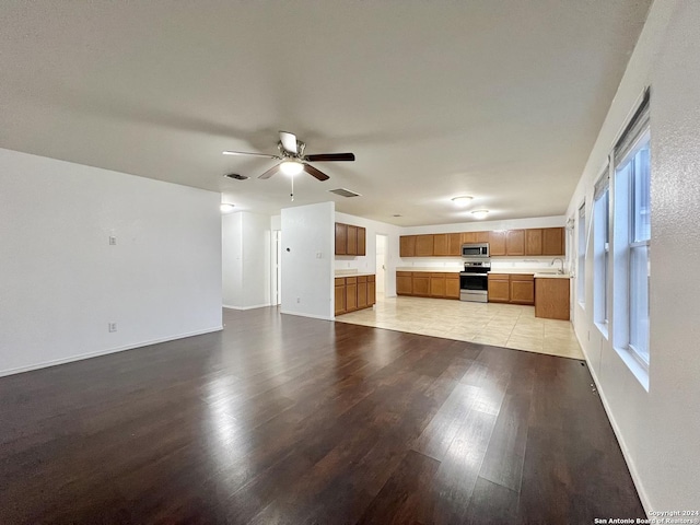 unfurnished living room featuring light hardwood / wood-style flooring and ceiling fan