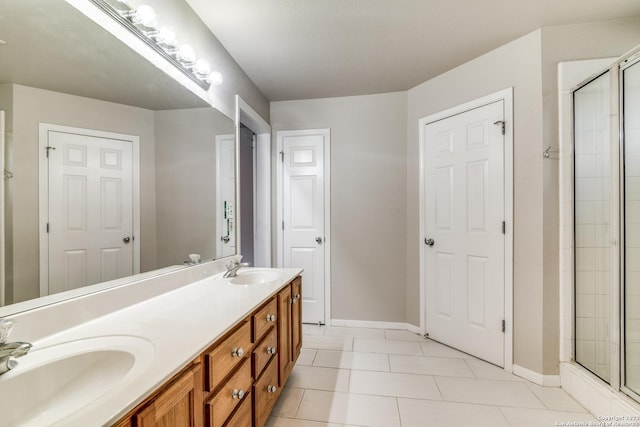 bathroom with tile patterned floors, vanity, a textured ceiling, and walk in shower