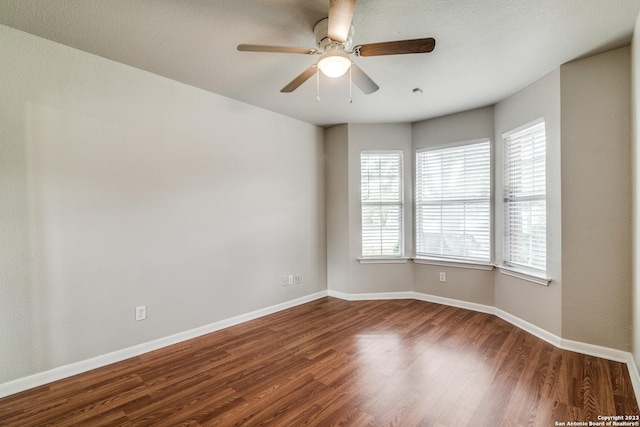 empty room featuring ceiling fan and dark hardwood / wood-style floors