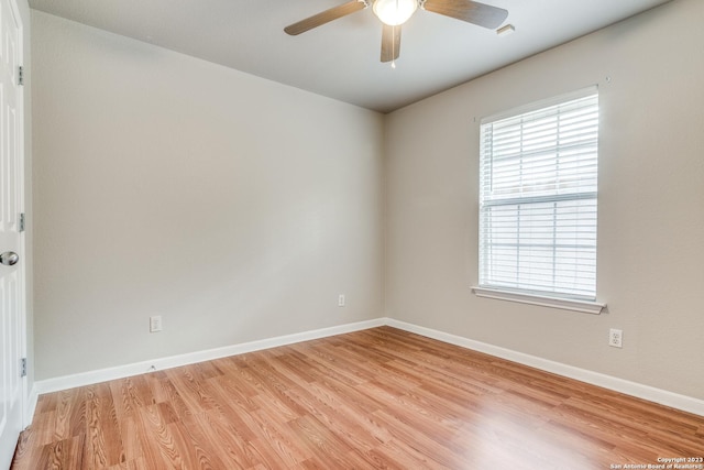 empty room with ceiling fan and light hardwood / wood-style floors