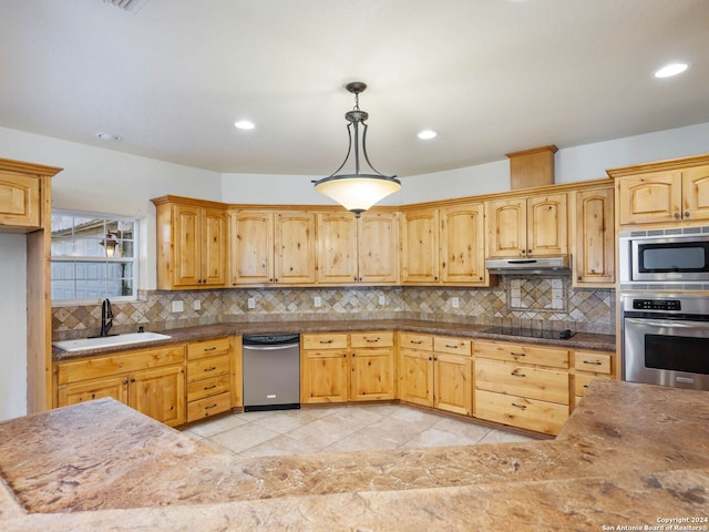 kitchen with pendant lighting, sink, stainless steel appliances, and tasteful backsplash