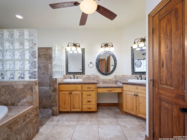 bathroom featuring tile patterned floors, tiled tub, ceiling fan, and vanity