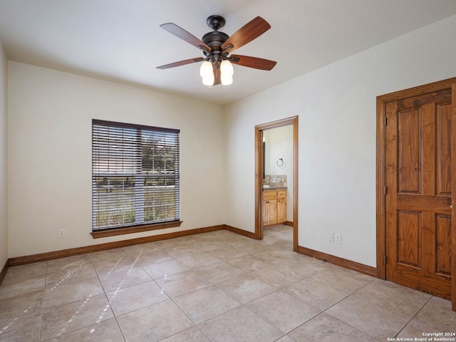 tiled empty room with ceiling fan