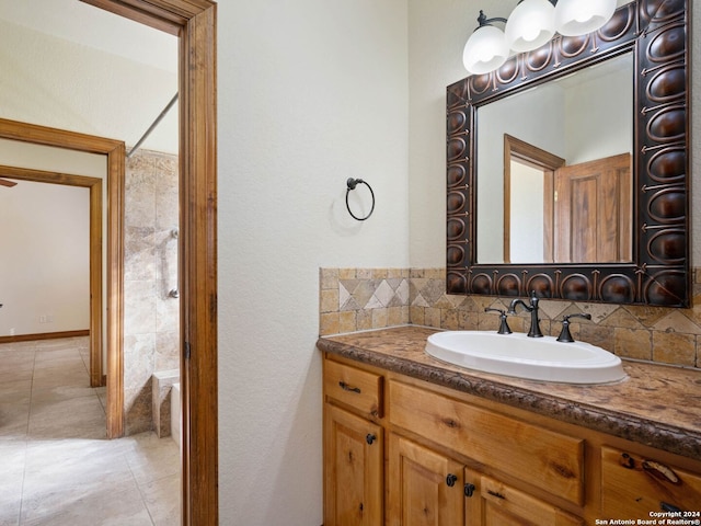 bathroom featuring tile patterned floors, decorative backsplash, and vanity