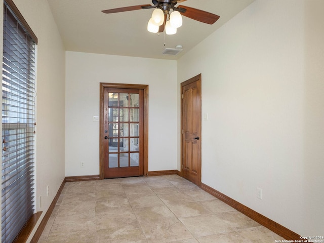 spare room featuring ceiling fan and light tile patterned flooring