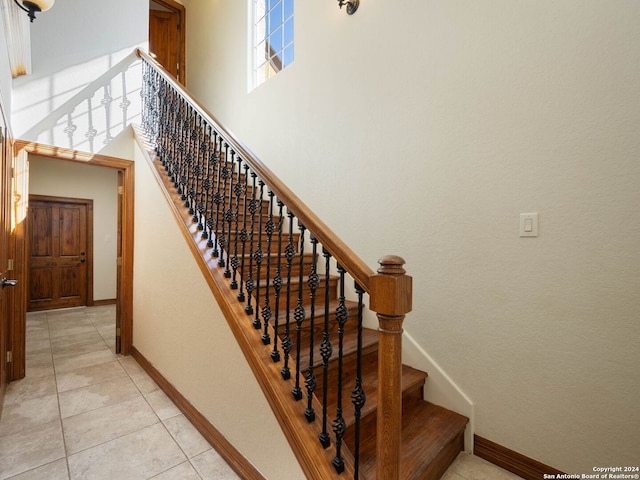 stairway with tile patterned flooring