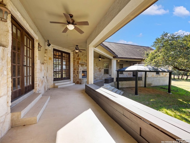 view of patio with french doors, ceiling fan, and a gazebo