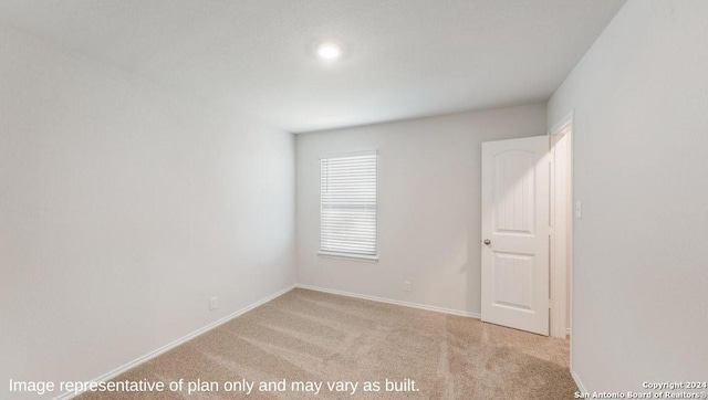 unfurnished room with light colored carpet