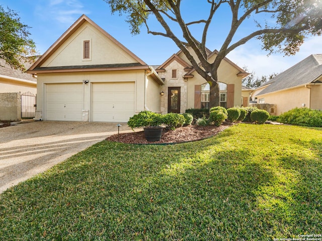 view of front of home with a front yard and a garage