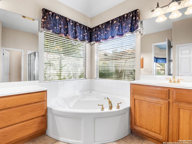 bathroom with tile patterned floors, vanity, and independent shower and bath