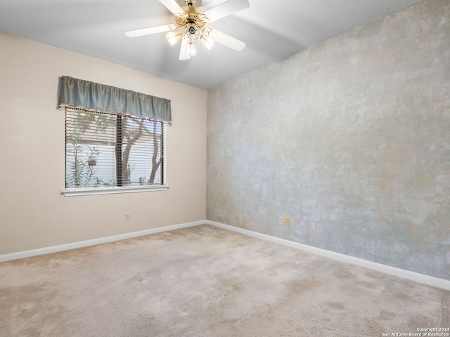 unfurnished room featuring ceiling fan and light carpet