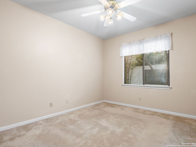 spare room with light carpet and ceiling fan