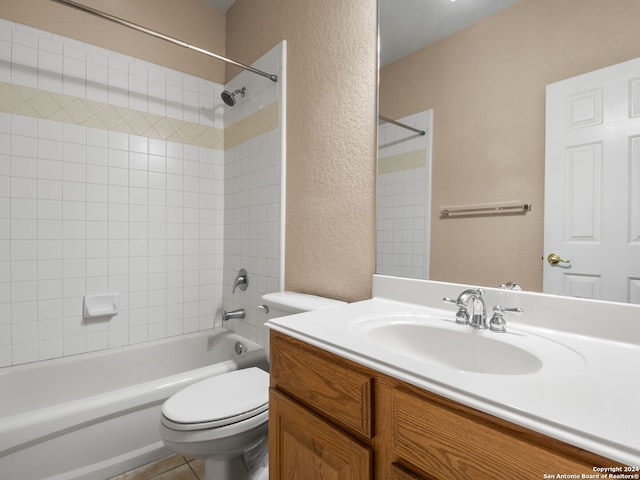 full bathroom featuring tile patterned floors, vanity, toilet, and tiled shower / bath combo