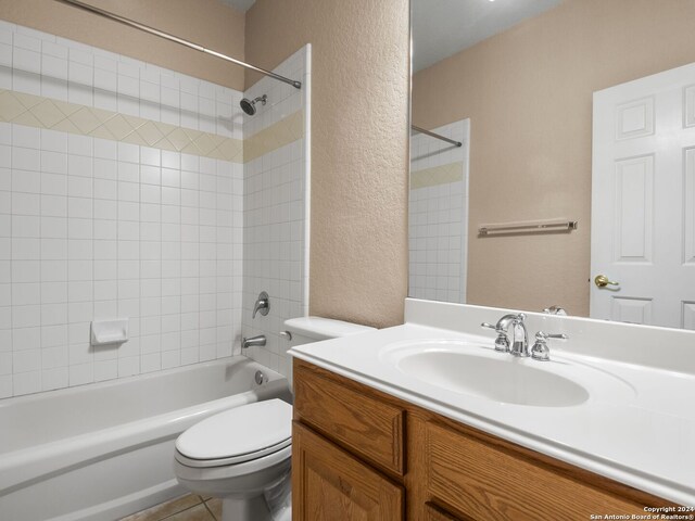 full bathroom with tile patterned flooring, vanity, toilet, and tiled shower / bath combo