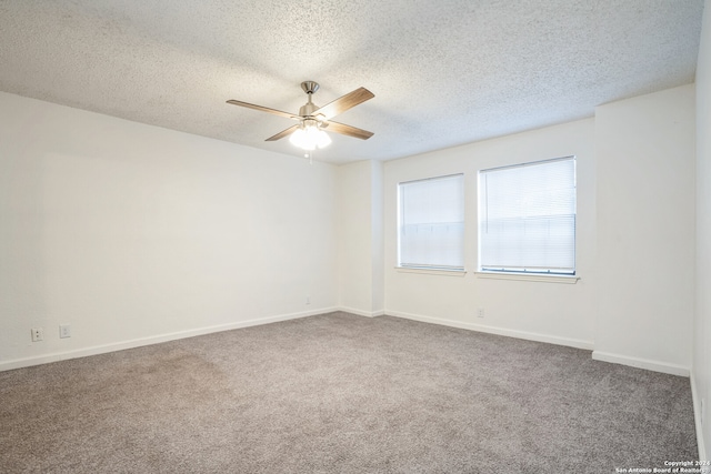 carpeted spare room featuring ceiling fan and a textured ceiling