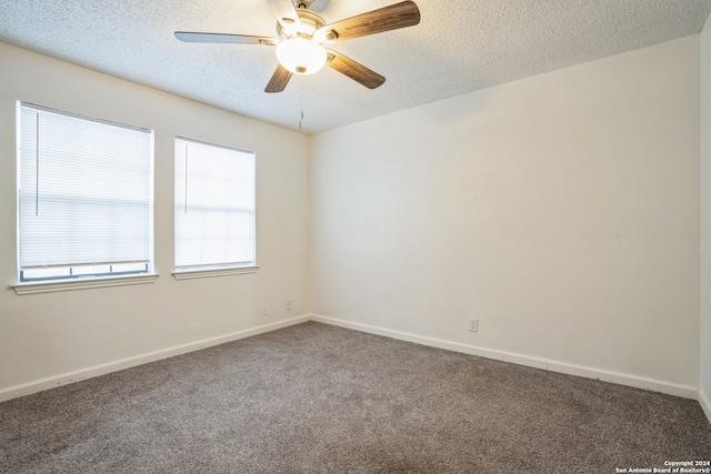 empty room with carpet flooring, ceiling fan, and a textured ceiling