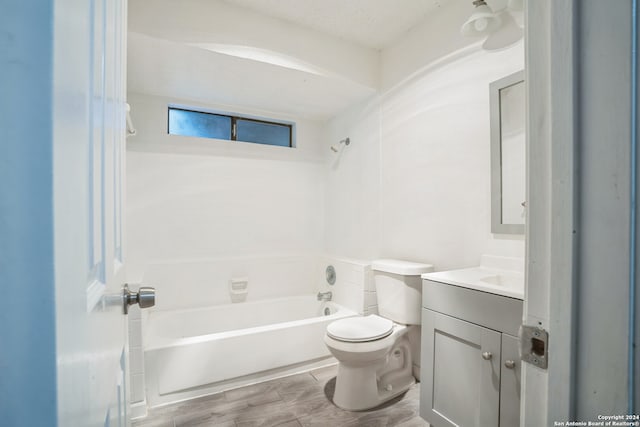 full bathroom with vanity, toilet, wood-type flooring, and bathing tub / shower combination