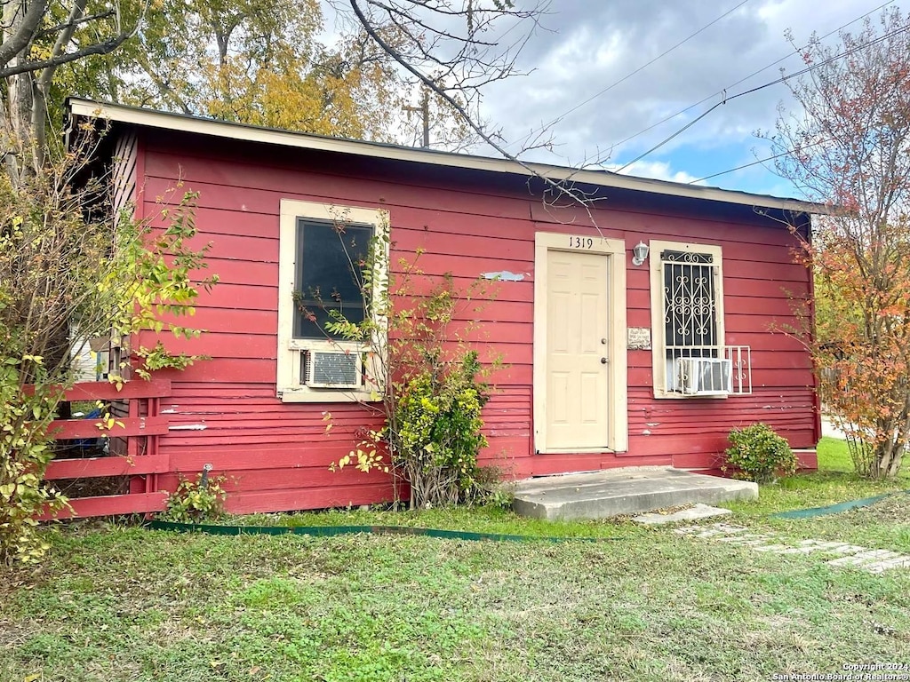 view of outbuilding featuring a lawn