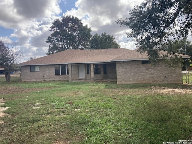 rear view of house with a yard