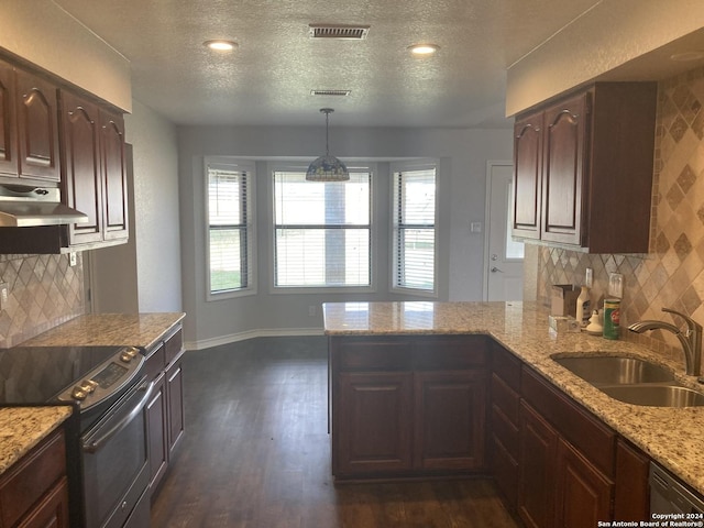 kitchen featuring sink, hanging light fixtures, dark hardwood / wood-style floors, light stone countertops, and stainless steel appliances