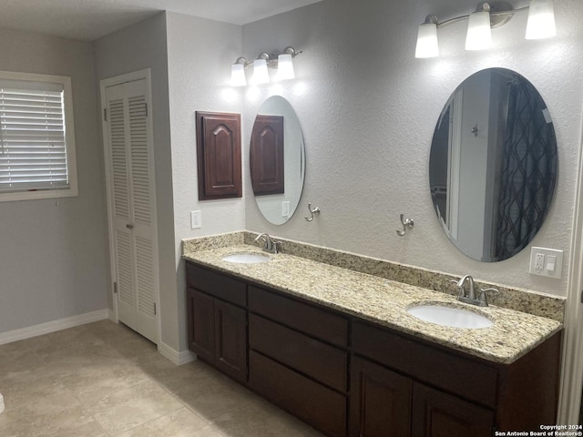 bathroom with tile patterned floors and vanity