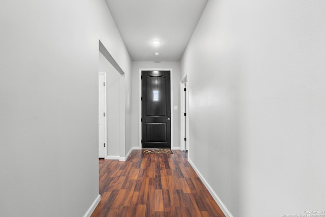 hallway with dark hardwood / wood-style floors