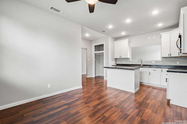 kitchen featuring dark hardwood / wood-style floors and white cabinetry