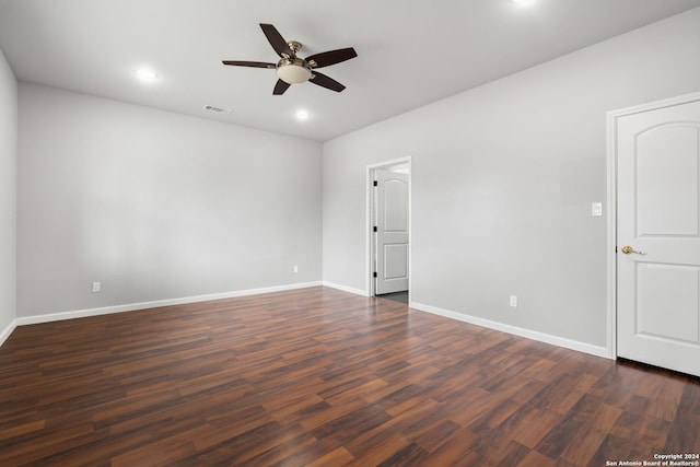 empty room with dark hardwood / wood-style flooring and ceiling fan