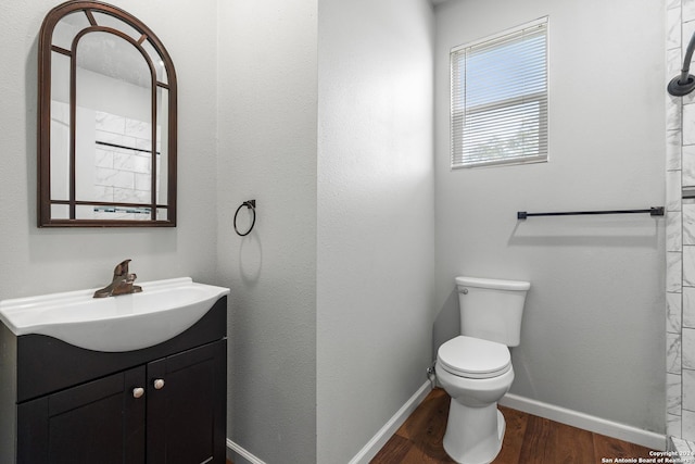 bathroom with vanity, wood-type flooring, and toilet