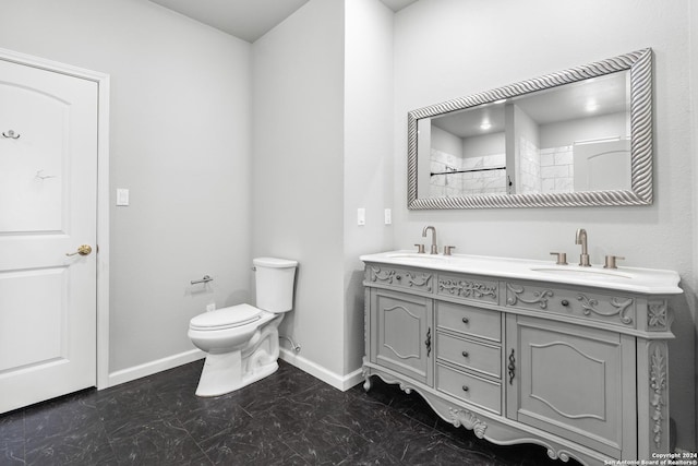 bathroom with toilet, vanity, and walk in shower