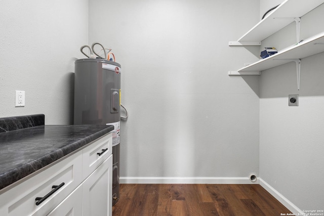 washroom with electric dryer hookup, dark hardwood / wood-style floors, and electric water heater