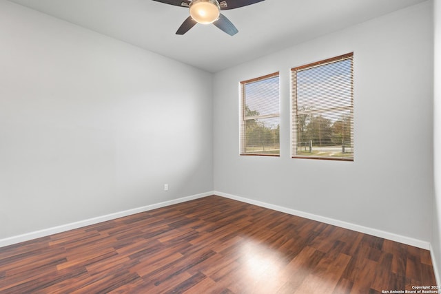 empty room featuring dark hardwood / wood-style floors and ceiling fan