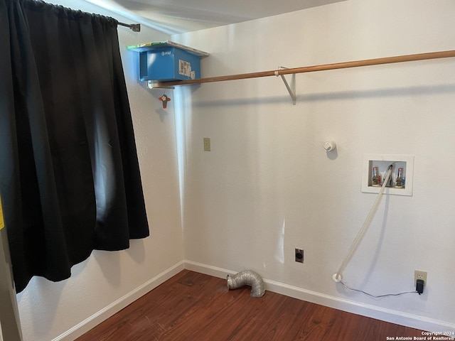 laundry room with washer hookup, dark wood-type flooring, hookup for a gas dryer, and electric dryer hookup