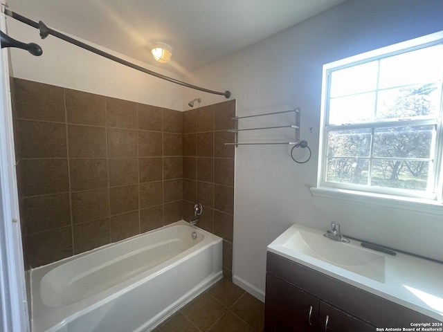 bathroom with vanity, tiled shower / bath combo, and tile patterned flooring