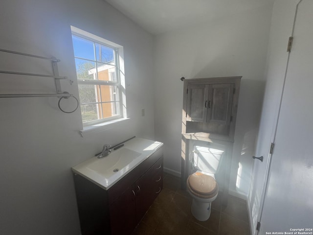 bathroom featuring tile patterned flooring, vanity, and toilet