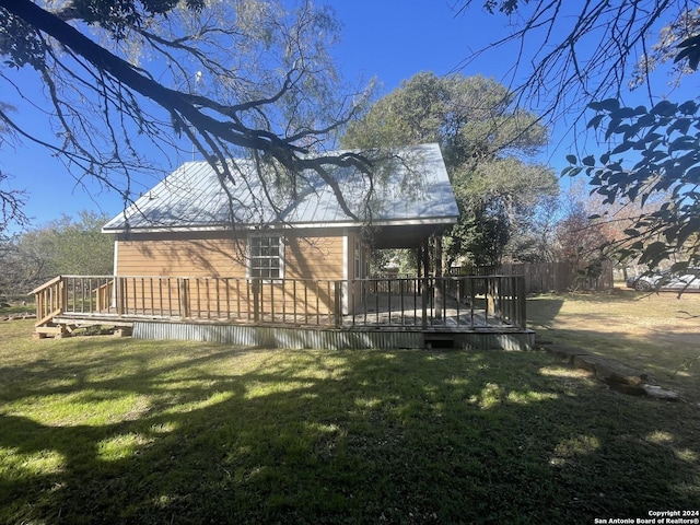 back of house featuring a yard and a wooden deck