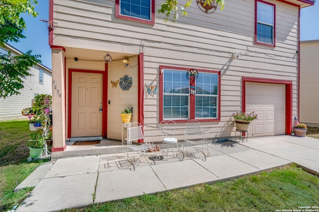 view of exterior entry with a garage