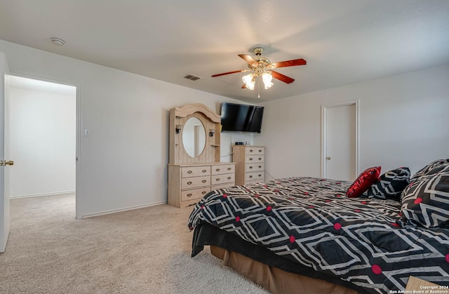 bedroom with ceiling fan and light carpet