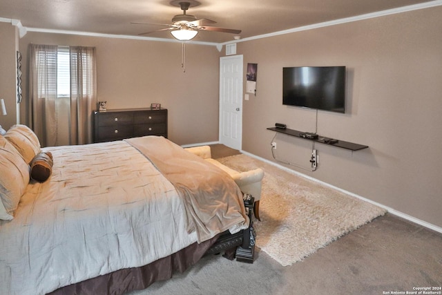 carpeted bedroom with ceiling fan and ornamental molding