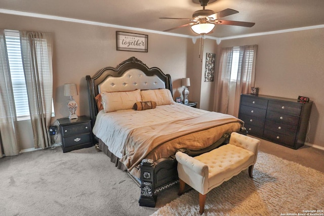 carpeted bedroom with ceiling fan and ornamental molding