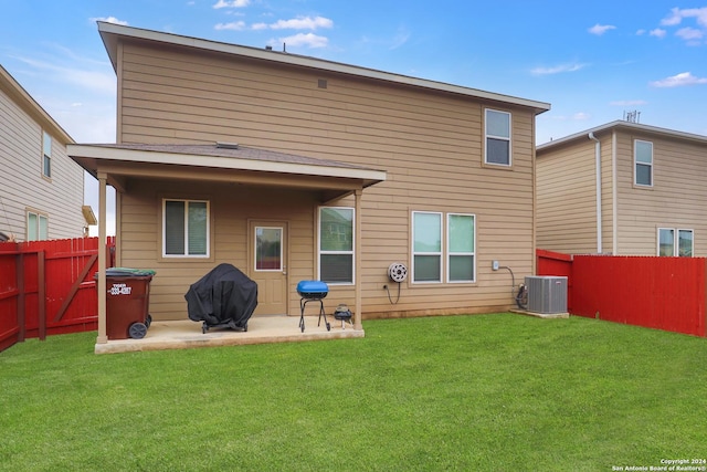 back of house with a patio area, central AC unit, and a lawn