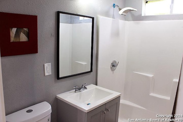 full bathroom with vanity, shower / bath combination, and toilet